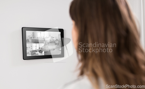 Image of woman having video control from tablet pc at home