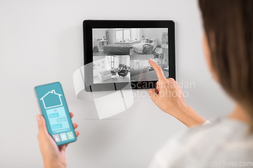 Image of woman having video control from tablet pc at home