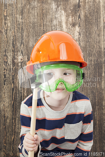 Image of boy in a helmet and hammer