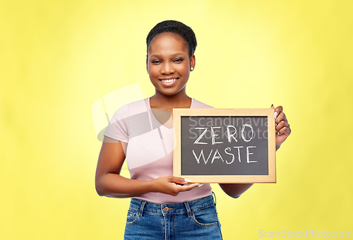 Image of happy woman holds chalkboard with zero waste words