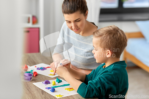 Image of mother and son playing with modeling clay at home