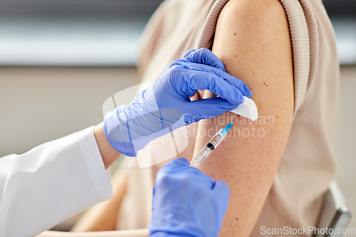 Image of close up of hand with syringe vaccinating patient