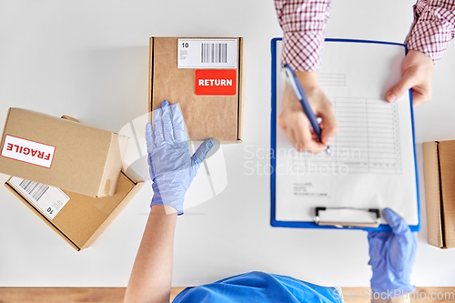 Image of customer making return of parcel and signing papers