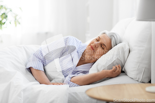 Image of senior woman sleeping in bed at home bedroom