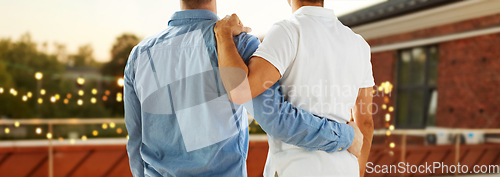 Image of close up of happy male gay couple hugging