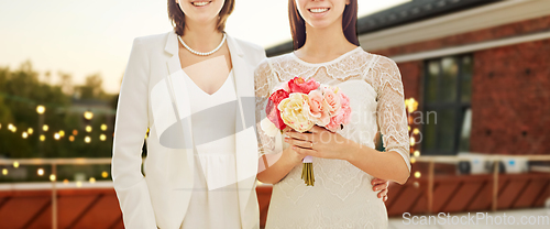 Image of close up of lesbian couple at wedding party