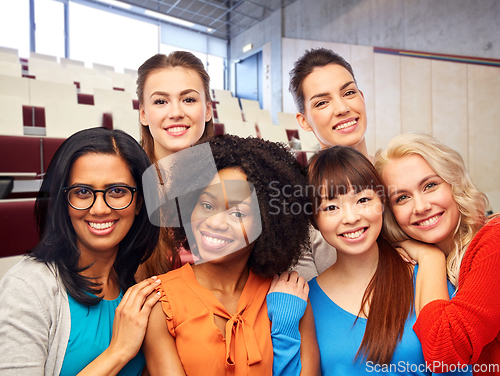 Image of group of happy student women hugging at university