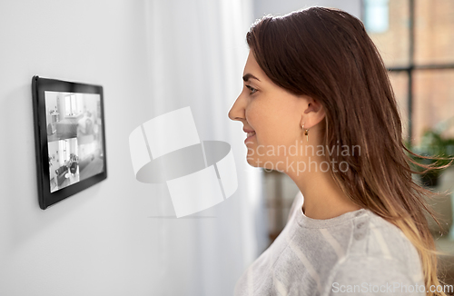 Image of woman having video control from tablet pc at home