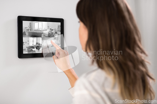 Image of woman having video control from tablet pc at home