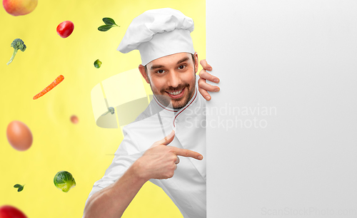 Image of happy smiling male chef with big white board
