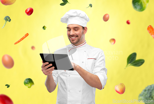 Image of happy smiling male chef with tablet pc computer