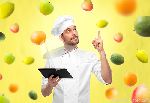 Image of male chef with tablet computer pointing finger up