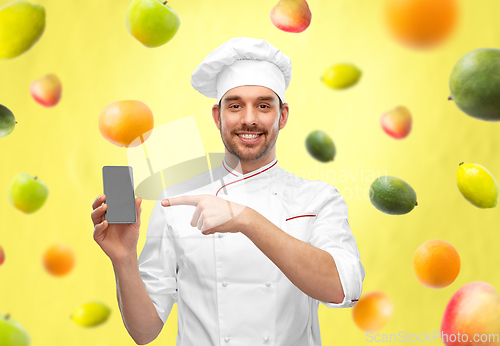 Image of happy smiling male chef showing smartphone