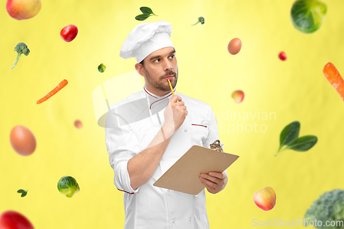 Image of thinking male chef with clipboard