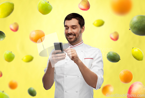 Image of happy smiling male chef with smartphone