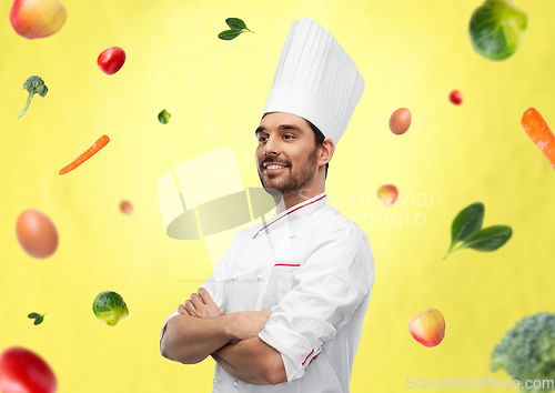 Image of happy smiling male chef in toque with crossed arms