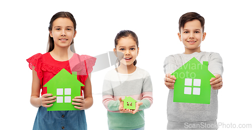 Image of smiling children holding green house icons