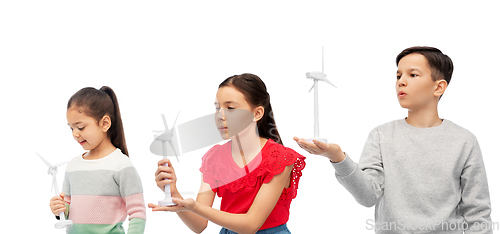 Image of smiling children with toy wind turbine