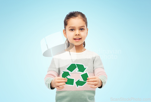 Image of smiling girl holding green recycling sign on blue