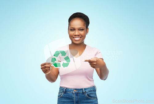 Image of smiling asian woman holding green recycling sign