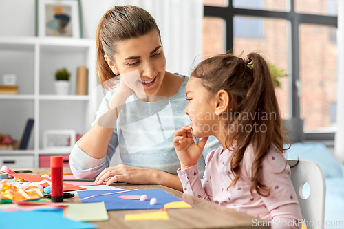 Image of daughter with mother making applique at home