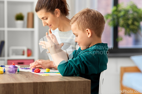 Image of mother and son playing with modeling clay at home