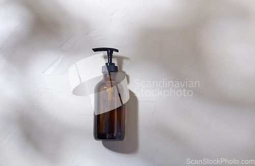 Image of bottle of shower gel or liquid soap with dispenser