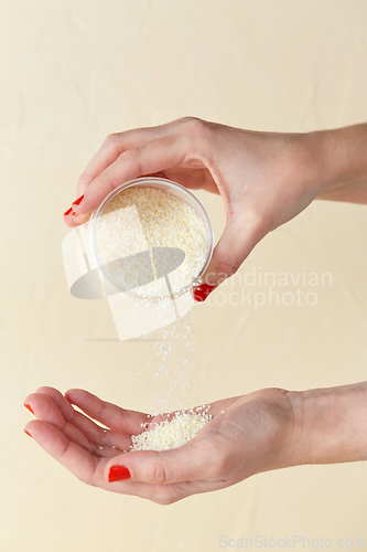 Image of hands with bath salt in jar