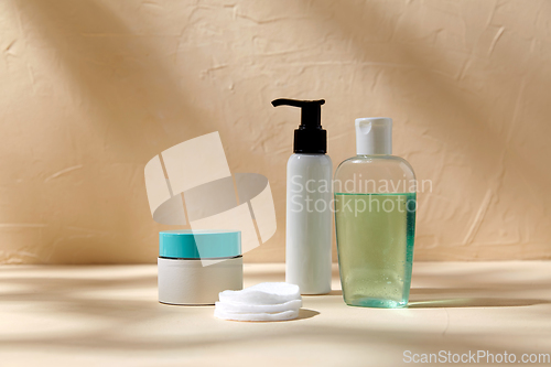 Image of body milk, lotion, moisurizer and cotton pads