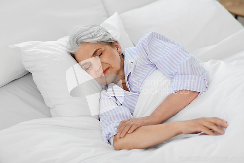 Image of senior woman sleeping in bed at home bedroom