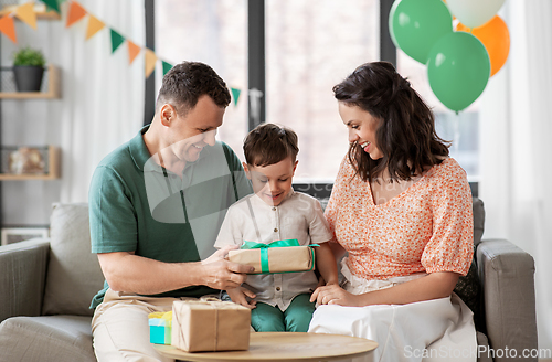Image of parents giving birthday present to little son