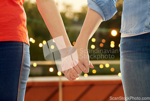 Image of close up of female gay couple holding hands