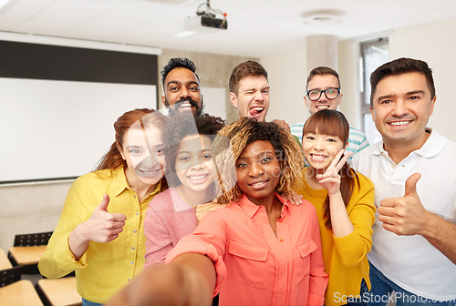 Image of international students and teacher taking selfie