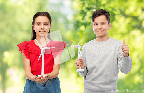 Image of smiling children with toy wind turbine