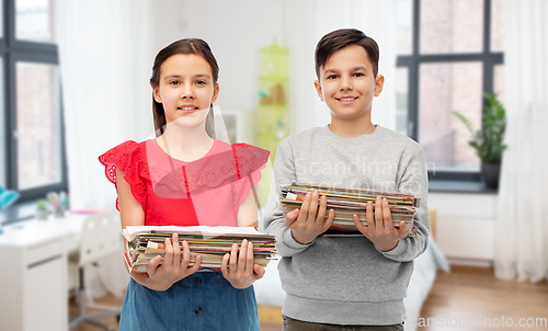 Image of happy children with magazines sorting paper waste