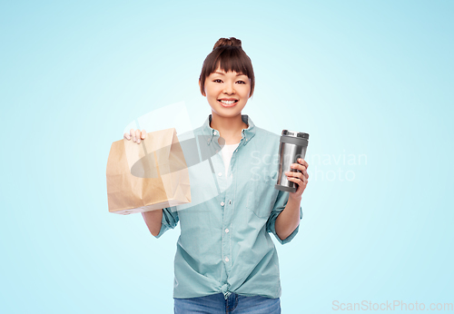Image of woman with thermo cup or tumbler for hot drinks
