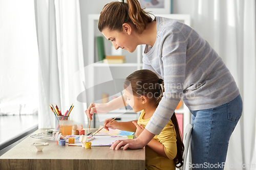 Image of mother with little daughter drawing at home