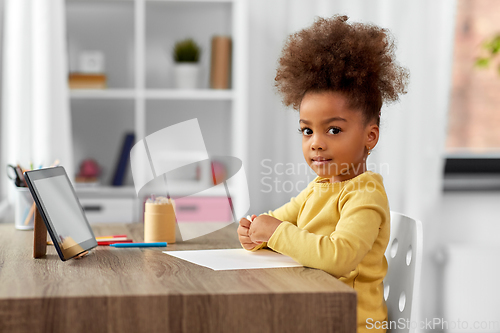 Image of little girl drawing with pencils at home