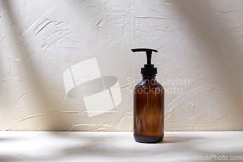 Image of bottle of shower gel or liquid soap with dispenser