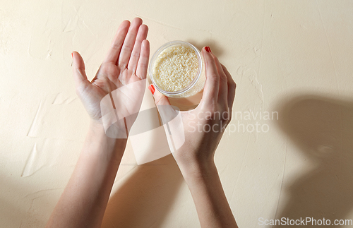 Image of hands with bath salt in jar