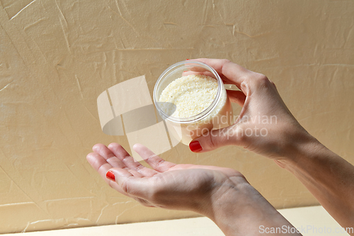 Image of hands with bath salt in jar