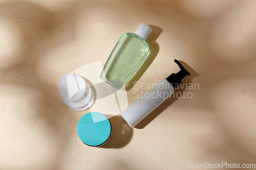 Image of body milk, lotion, moisurizer and cotton pads
