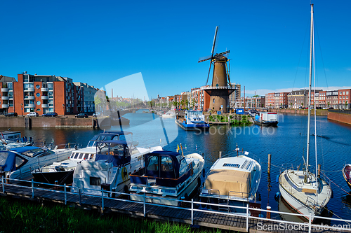 Image of View of the harbour of Delfshaven and the old grain mill De Destilleerketel. Rotterdam, Netherlands
