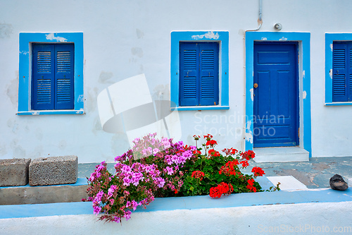 Image of Greek white house with blue door and window blinds Oia village on Santorini island in Greece