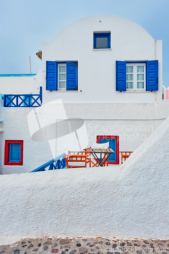 Image of Greek white house with blue door and window blinds Oia village on Santorini island in Greece