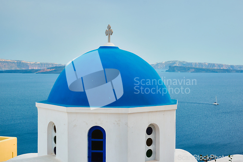 Image of Famous view from viewpoint of Santorini Oia village with blue dome of greek orthodox Christian church