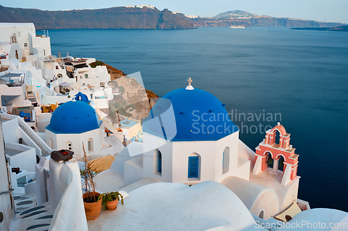 Image of Famous view from viewpoint of Santorini Oia village with blue dome of greek orthodox Christian church