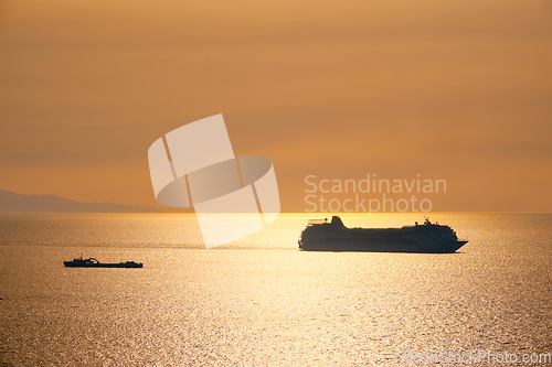 Image of Cruise ship silhouette in Aegean sea on sunset