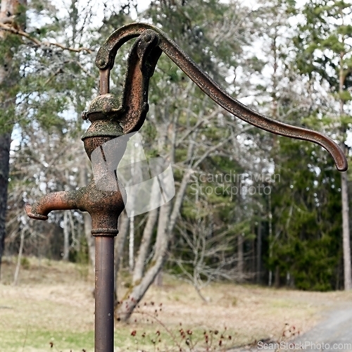 Image of old rusty water column outdoors 