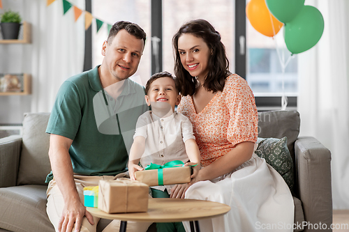 Image of parents giving birthday present to little son